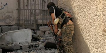 A member of the Syrian Democratic Forces stands as he prepares to advance toward Islamic State positions in Seif Al Dawla district of Raqqa. 


REUTERS/Zohra Bensemra